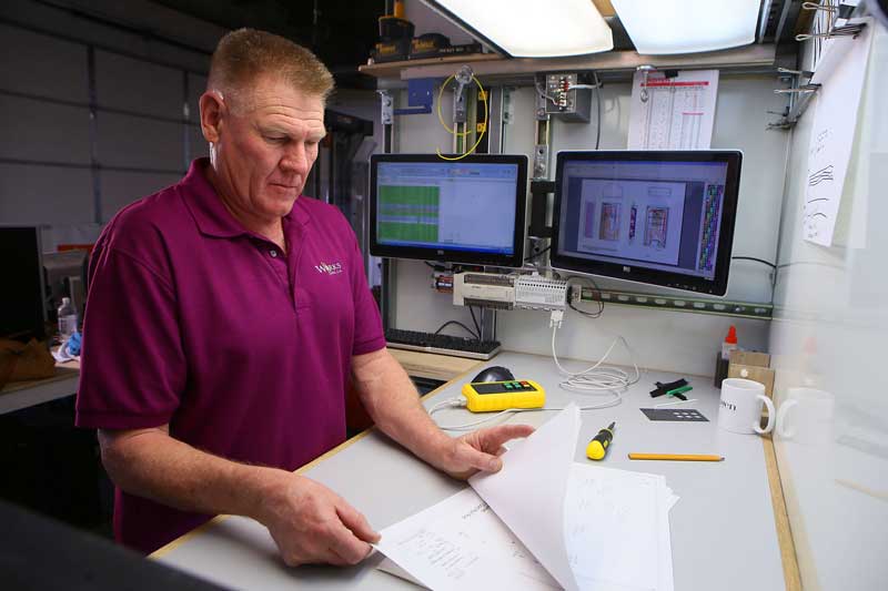 Randal Worker reviewing schematic drawings 