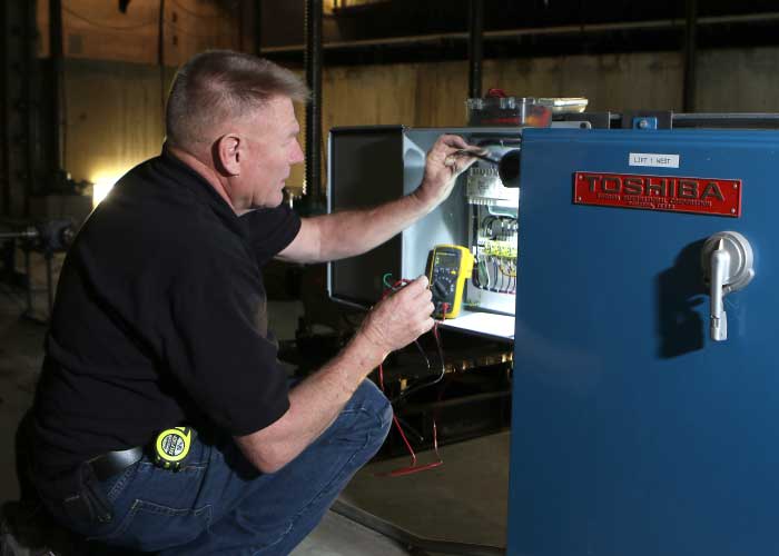 Randy Worker inspecting an electrical panel